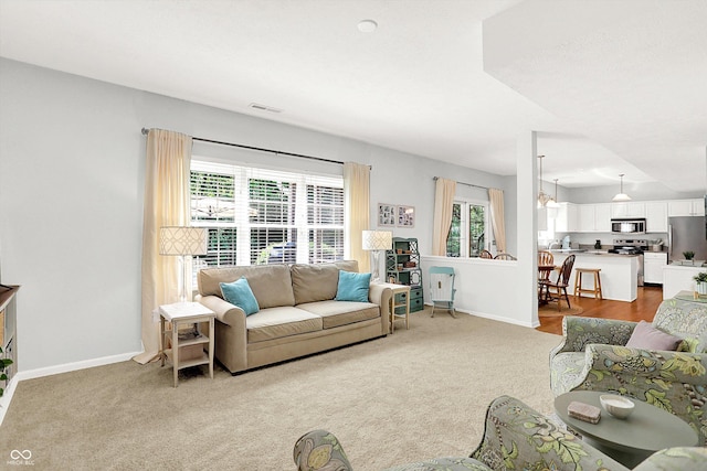 10965 Fairway Ridge Ln, Fishers, IN 46037 - carpeted living area featuring healthy amount of natural light and baseboards