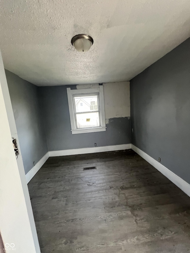 409 Parkway Ave, Indianapolis, IN 46225 - empty room with a textured ceiling, wood finished floors, and baseboards