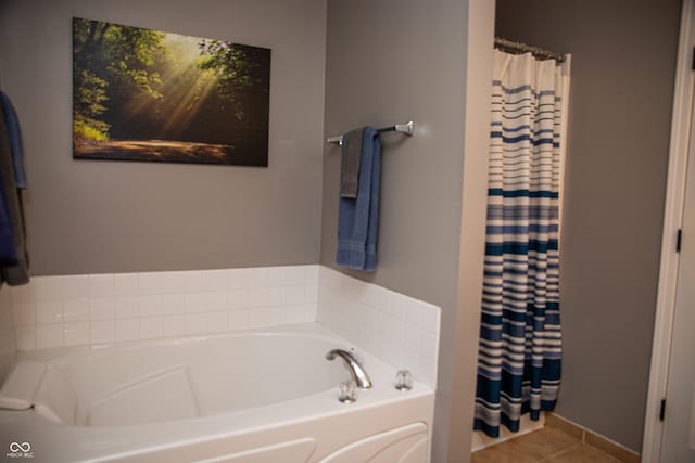 bathroom with a garden tub, tile patterned floors, and curtained shower