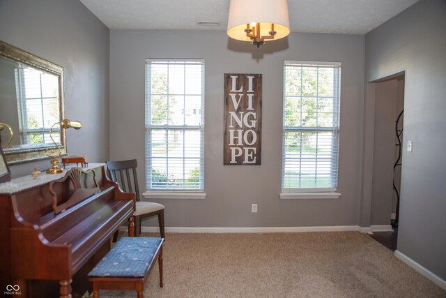 sitting room with plenty of natural light and baseboards