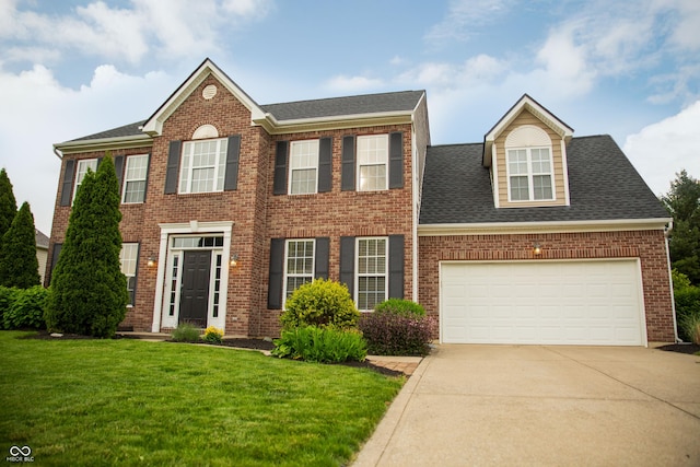 view of front of home with driveway, a front yard, brick siding, and an attached garage