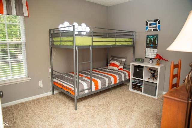 bedroom with carpet and baseboards
