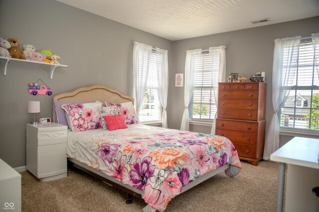 bedroom featuring light colored carpet