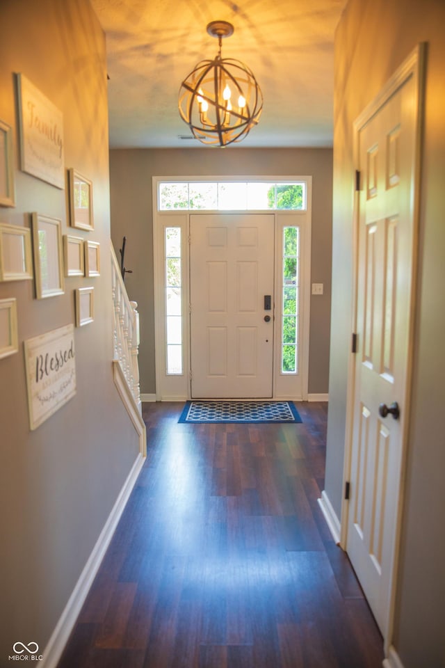 entryway with baseboards, plenty of natural light, and wood finished floors