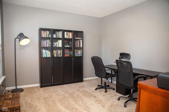 office space with carpet, a textured ceiling, and baseboards
