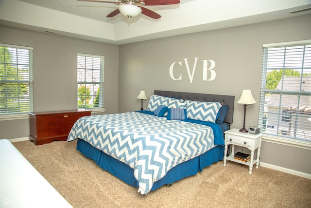 carpeted bedroom with baseboards and a ceiling fan