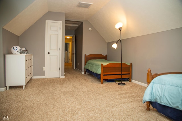 carpeted bedroom with lofted ceiling and baseboards