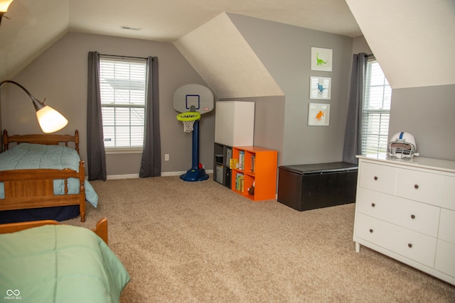 carpeted bedroom with vaulted ceiling and baseboards