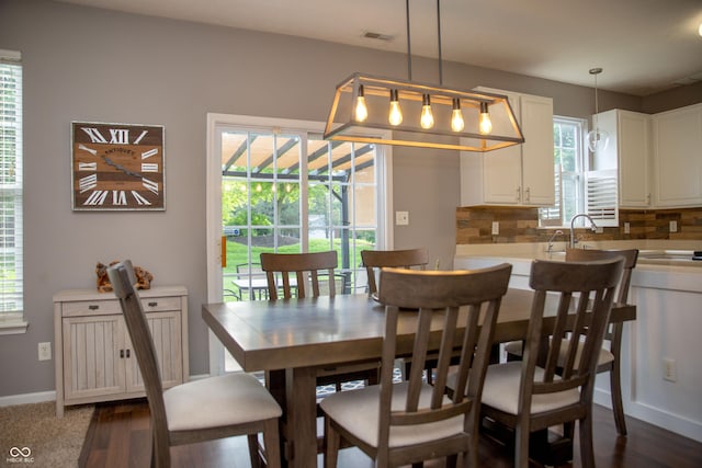 dining room with baseboards and dark wood-style floors