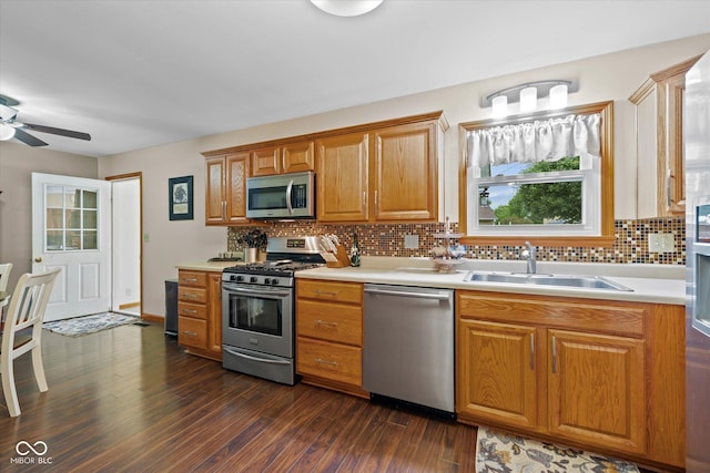 580 Northgate Dr, Greenwood, IN 46143 - kitchen with appliances with stainless steel finishes, a sink, dark wood finished floors, and light countertops