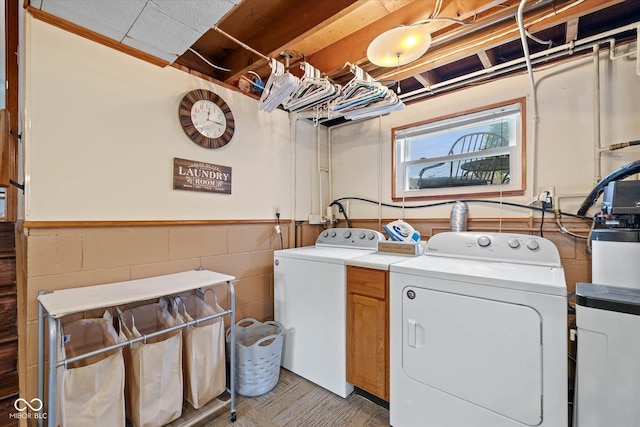 580 Northgate Dr, Greenwood, IN 46143 - laundry area with washer and dryer, cabinet space, and wainscoting