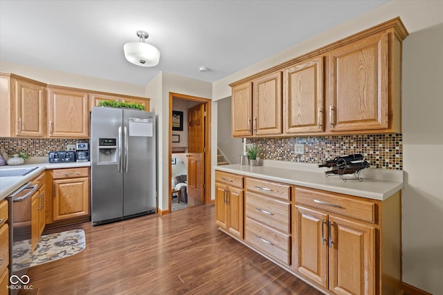 580 Northgate Dr, Greenwood, IN 46143 - kitchen with appliances with stainless steel finishes, backsplash, dark wood-style floors, and light countertops