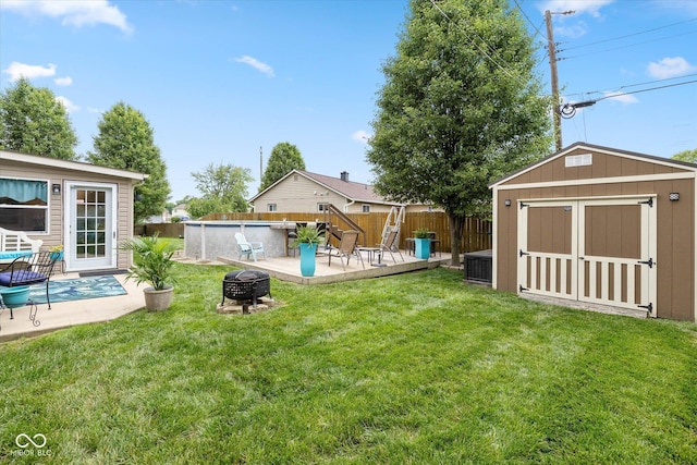 580 Northgate Dr, Greenwood, IN 46143 - view of yard featuring a fire pit, a wooden deck, and a patio area