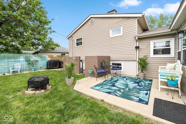 580 Northgate Dr, Greenwood, IN 46143 - back of property featuring an outdoor fire pit and a patio