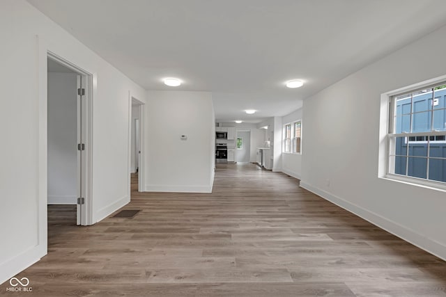 1411 N Grant Ave, Indianapolis, IN 46201 - hallway featuring baseboards and light wood-style floors