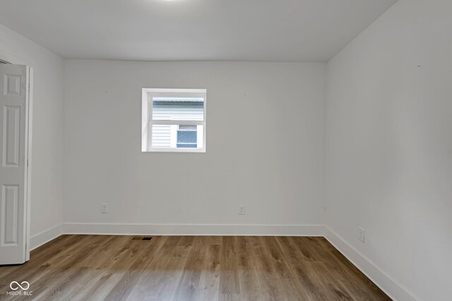 1411 N Grant Ave, Indianapolis, IN 46201 - unfurnished room featuring baseboards and wood finished floors