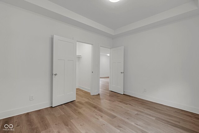 1411 N Grant Ave, Indianapolis, IN 46201 - unfurnished bedroom with light wood-style flooring and baseboards