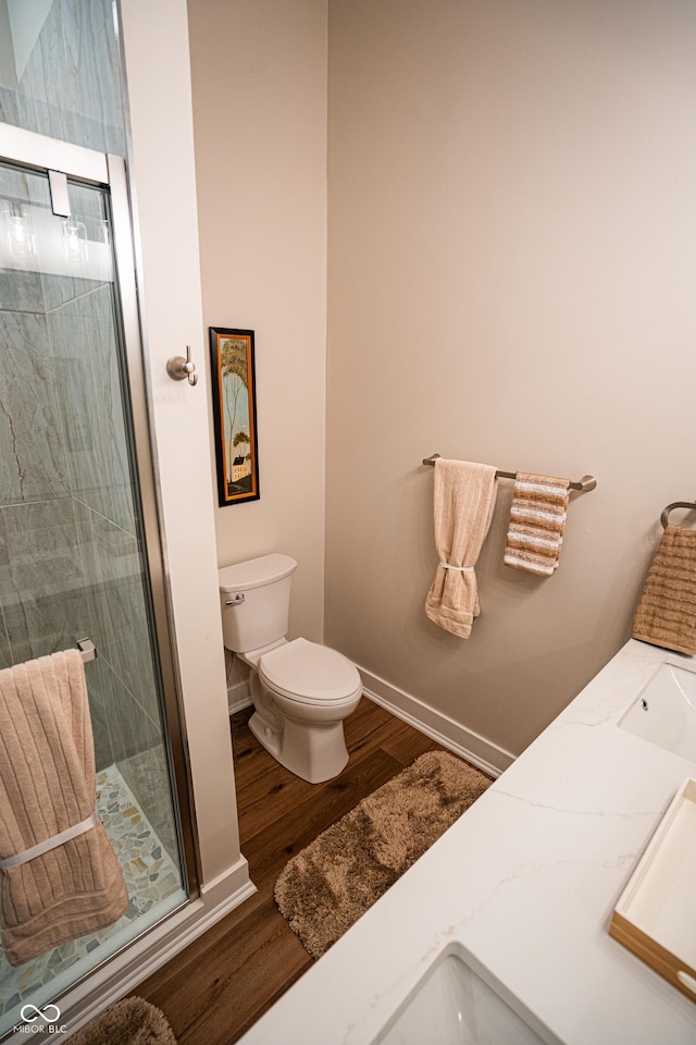 3463 Plum Creek Rd, Nashville, IN 47448 - full bath with wood finished floors, a shower stall, toilet, baseboards, and vanity