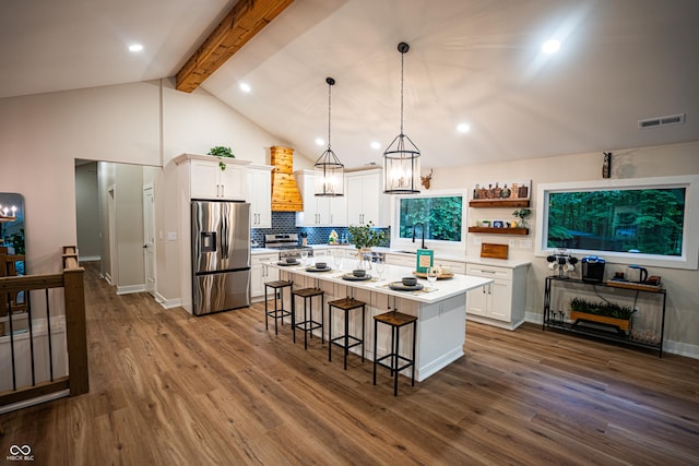 3463 Plum Creek Rd, Nashville, IN 47448 - kitchen featuring stainless steel appliances, a sink, a kitchen breakfast bar, white cabinetry, and beamed ceiling