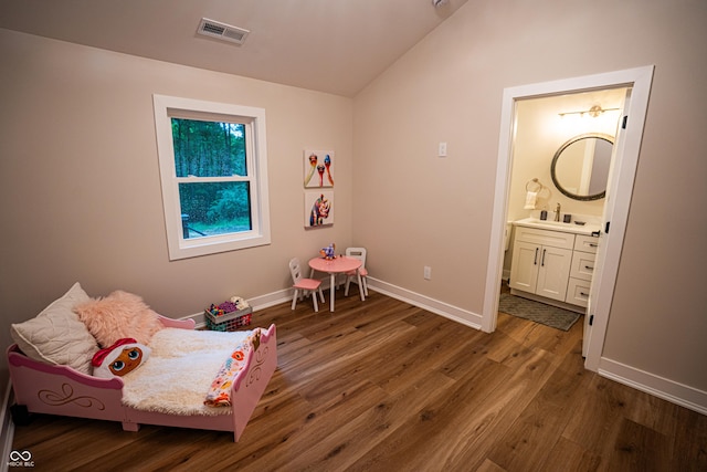 3463 Plum Creek Rd, Nashville, IN 47448 - bedroom featuring vaulted ceiling, dark wood-style floors, baseboards, connected bathroom, and a sink