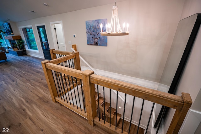 3463 Plum Creek Rd, Nashville, IN 47448 - stairs with a chandelier, wood finished floors, and baseboards