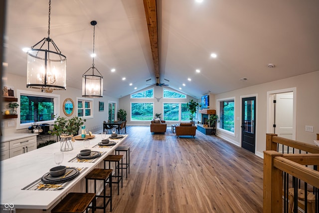3463 Plum Creek Rd, Nashville, IN 47448 - kitchen with wood finished floors, light countertops, a kitchen breakfast bar, hanging light fixtures, and open floor plan