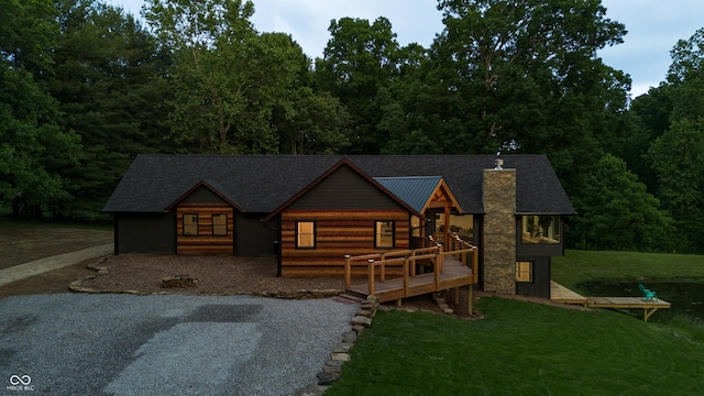 3463 Plum Creek Rd, Nashville, IN 47448 - view of front of home featuring a chimney, a front lawn, a wooden deck, and metal roof