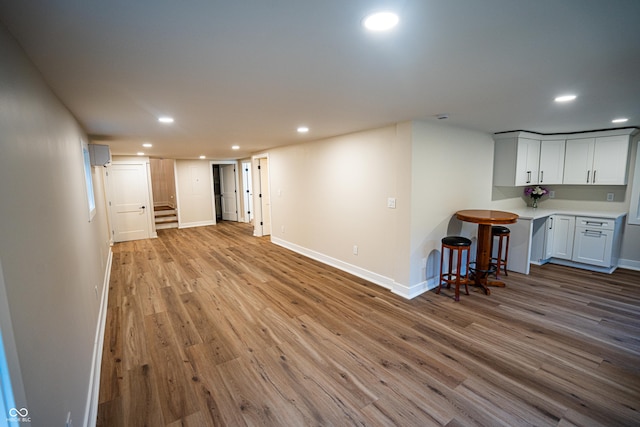 3463 Plum Creek Rd, Nashville, IN 47448 - finished basement featuring baseboards, wood finished floors, recessed lighting, stairs, and a wall mounted AC