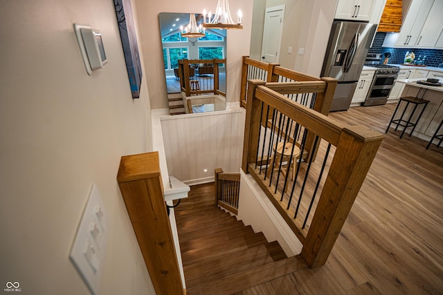 3463 Plum Creek Rd, Nashville, IN 47448 - staircase featuring a chandelier and wood finished floors