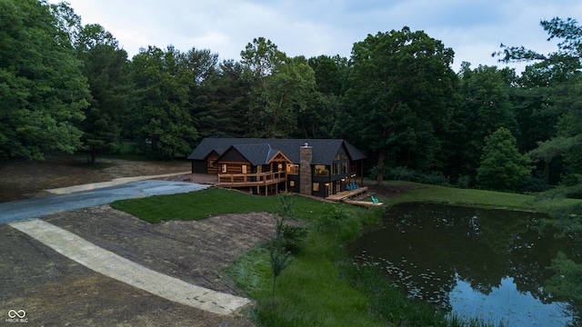 3463 Plum Creek Rd, Nashville, IN 47448 - view of front of home featuring a wooded view, driveway, and a deck with water view