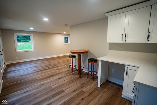 3463 Plum Creek Rd, Nashville, IN 47448 - kitchen with recessed lighting, wood finished floors, white cabinetry, light stone countertops, and baseboards