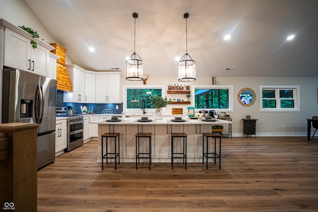 3463 Plum Creek Rd, Nashville, IN 47448 - kitchen featuring stainless steel appliances, a kitchen bar, decorative backsplash, white cabinets, and a chandelier