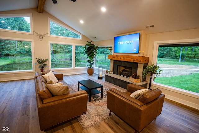 3463 Plum Creek Rd, Nashville, IN 47448 - living room featuring hardwood / wood-style flooring, a tiled fireplace, beam ceiling, baseboards, and recessed lighting