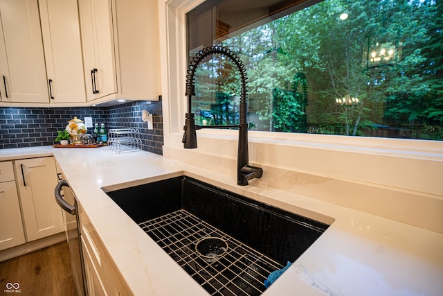 3463 Plum Creek Rd, Nashville, IN 47448 - kitchen view of a sink, decorative backsplash, dark wood-type flooring, white cabinetry, and light stone counters