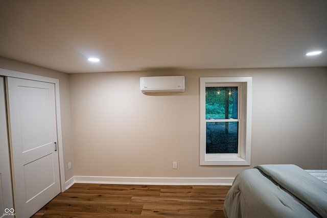 3463 Plum Creek Rd, Nashville, IN 47448 - bedroom with a wall unit AC, recessed lighting, dark wood-type flooring, and baseboards