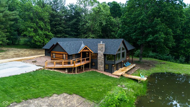 3463 Plum Creek Rd, Nashville, IN 47448 - rear view of property featuring a chimney, a shingled roof, a lawn, a deck with water view, and stone siding