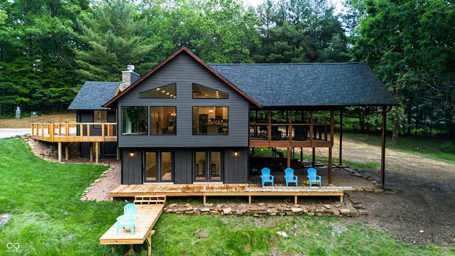 3463 Plum Creek Rd, Nashville, IN 47448 - rear view of house with roof with shingles, a chimney, a deck, and a yard