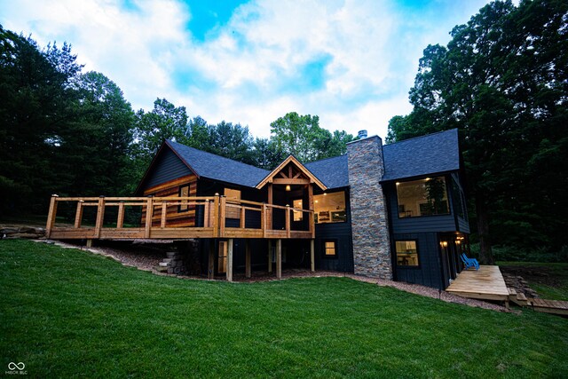 3463 Plum Creek Rd, Nashville, IN 47448 - back of property with a deck, a chimney, a lawn, and roof with shingles