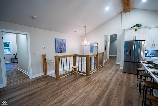 3463 Plum Creek Rd, Nashville, IN 47448 - kitchen featuring stainless steel fridge with ice dispenser, dark wood-style floors, white cabinets, a chandelier, and beamed ceiling