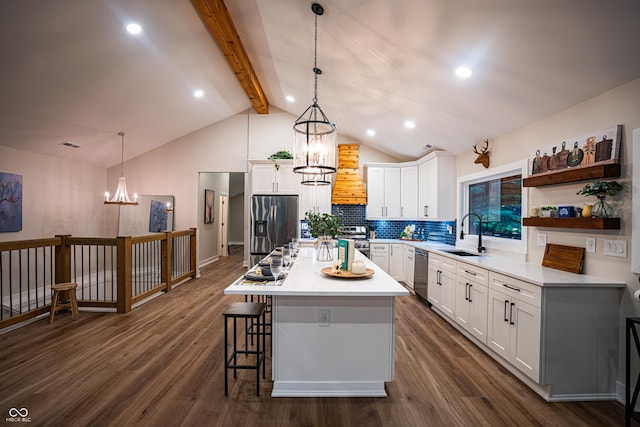 3463 Plum Creek Rd, Nashville, IN 47448 - kitchen featuring stainless steel appliances, a sink, a kitchen breakfast bar, beam ceiling, and premium range hood