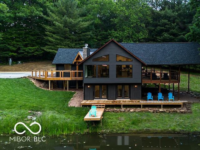 3463 Plum Creek Rd, Nashville, IN 47448 - rear view of house featuring a deck, a yard, a chimney, and roof with shingles