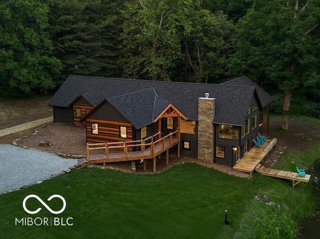 3463 Plum Creek Rd, Nashville, IN 47448 - rear view of property featuring a yard, a wooden deck, a chimney, and a forest view