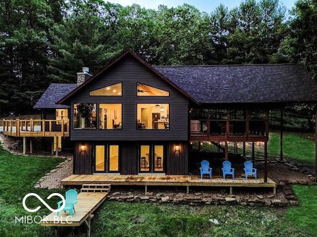 3463 Plum Creek Rd, Nashville, IN 47448 - back of property with a balcony, a chimney, a lawn, and a shingled roof