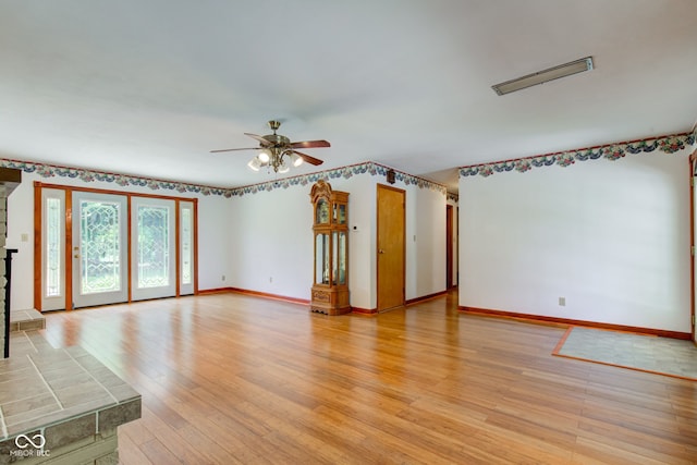 132 S First St, Jamestown, IN 46147 - unfurnished living room with a ceiling fan, light wood finished floors, and baseboards
