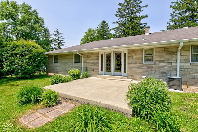 132 S First St, Jamestown, IN 46147 - back of house featuring stone siding, a chimney, central AC, a yard, and a patio