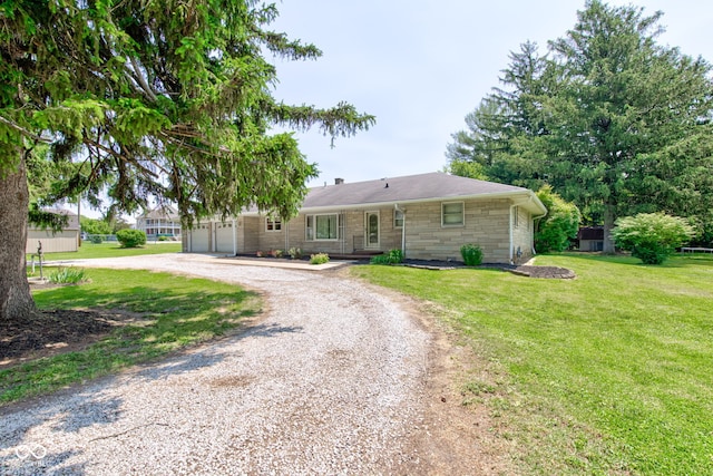 132 S First St, Jamestown, IN 46147 - ranch-style house featuring curved driveway, stone siding, a front lawn, and a garage