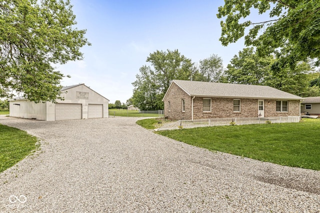 312 W Clark Ln, Fairland, IN 46126 - view of front facade featuring a garage, an outdoor structure, brick siding, and a shingled roof