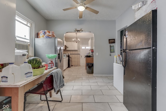 952 Lasalle St, Indianapolis, IN 46201 - kitchen featuring stainless steel appliances, a ceiling fan, healthy amount of natural light, arched walkways, and a textured ceiling