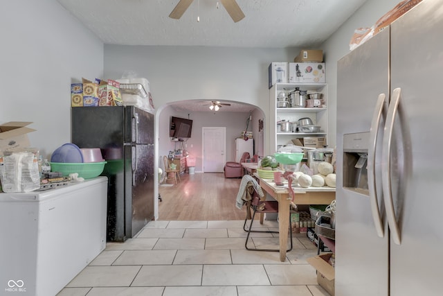 952 Lasalle St, Indianapolis, IN 46201 - kitchen featuring stainless steel fridge with ice dispenser, ceiling fan, freestanding refrigerator, light tile patterned floors, and fridge