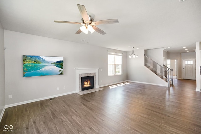 6830 Park Grove Blvd, Whitestown, IN 46075 - unfurnished living room with wood finished floors, stairway, and baseboards